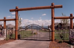 Complete Entry With Gate, Fence, Logs And Stone Columns